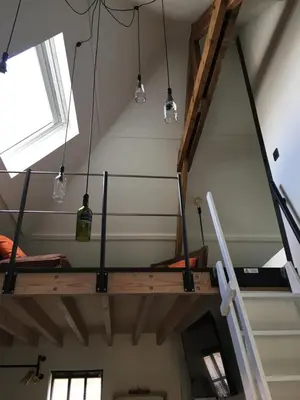 a room with several lights hanging from the ceiling at B&B Sint-Mariaburg in Antwerp