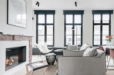 a living room with a couch and a fireplace at MAISON12 - Design apartments with terrace and view over Ghent towers in Ghent