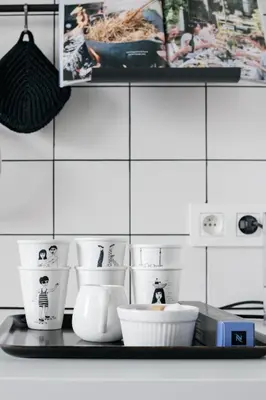a shelf with cups and other kitchen items on it at MAISON12 - Design apartments with terrace and view over Ghent towers in Ghent