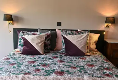 a bed with pillows and a dog sitting on it at Nova Zembla in Mechelen