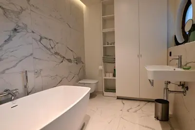 a white bathroom with a tub and a sink at Nova Zembla in Mechelen