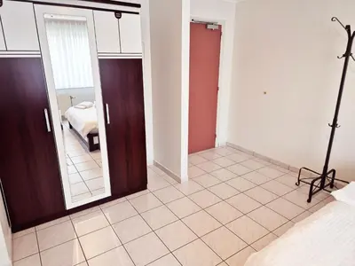 a bedroom with a mirror and a bed in a room at Flatpolis Brussels Airport Budget in Diegem