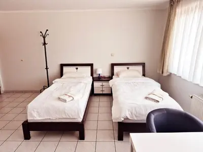 a room with two beds and a chair in it at Flatpolis Brussels Airport Budget in Diegem