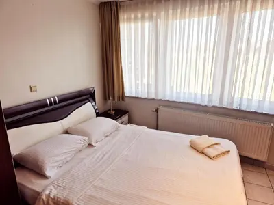 a bedroom with a bed with two pillows on it at Flatpolis Brussels Airport Budget in Diegem
