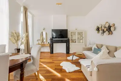 a living room with a couch and a table at Bel appart proche de gare du Midi, à côté du Centre Ville in Brussels
