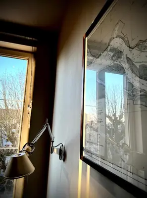 a lamp in a room with a large window at L'atique by Agelandkaai be with Free Parking in Ghent