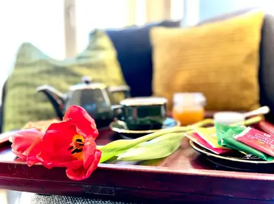 a table with a red flower on top of it at L'atique by Agelandkaai be with Free Parking in Ghent