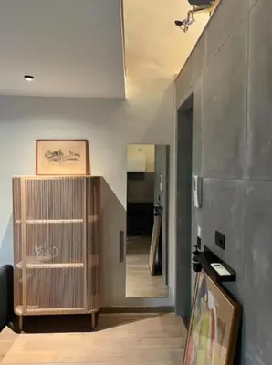 a living room with a large wooden cabinet and a hallway at L'atique by Agelandkaai be with Free Parking in Ghent