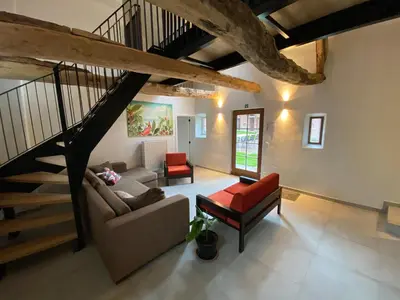 a living room with a staircase and a couch at Quadratum 1769 in Herzele