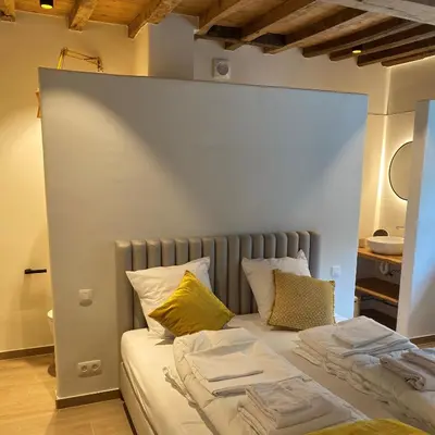 a bed with two pillows at Quadratum 1769 in Herzele