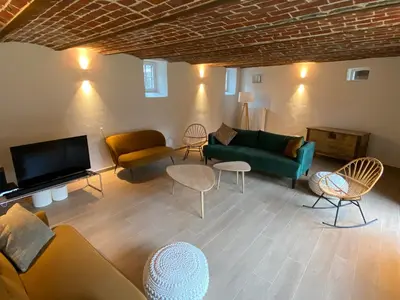a living room with a couch and chairs and a tv at Quadratum 1769 in Herzele