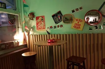a bar with a wooden radiator and a table and chairs at Vakantiewoning in Mol centrum met eigen bar 