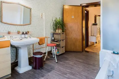 a bathroom with a sink and a mirror at Vakantiewoning in Mol centrum met eigen bar 