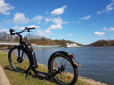 a bike parked next to a body of water at Vakantiewoning in Mol centrum met eigen bar 