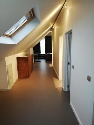 an attic hallway with a skylight in a building at NUVOLA Summer Spring in Zottegem