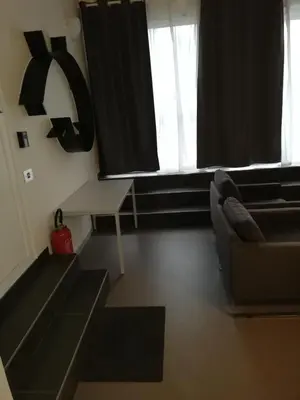 a living room with a couch and a table at NUVOLA Summer Spring in Zottegem