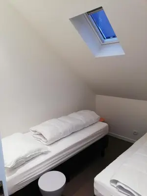 a room with two beds and a skylight at NUVOLA Summer Spring in Zottegem