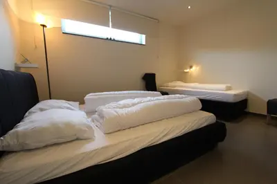 a room with three beds with white pillows at NUVOLA VIEW in Zottegem
