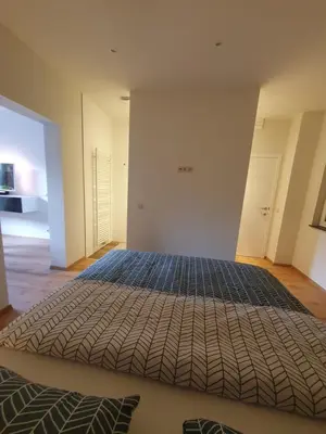a bedroom with a large bed in a room at Brussels North - Pajot Apartments in Wemmel