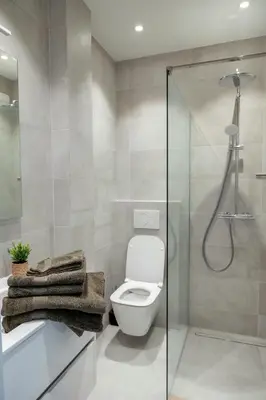 a bathroom with a toilet and a glass shower at Brussels North - Pajot Apartments in Wemmel