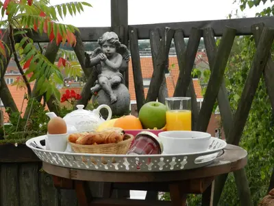 a tray of breakfast food on a table with a statue at B&B Basilique in Brussels