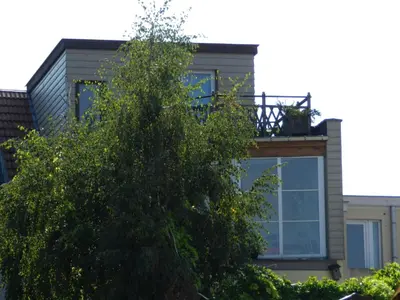 a house with a balcony on top of a tree at B&B Basilique in Brussels