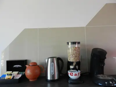 a kitchen counter with a blender and other appliances at B&B Basilique in Brussels