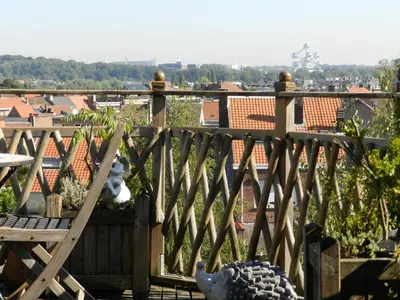 a wooden balcony with a view of a city at B&B Basilique in Brussels