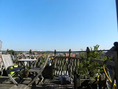 a balcony with chairs and a table and a view at B&B Basilique in Brussels