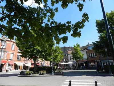 a street in a town with buildings and trees at B&B Basilique in Brussels
