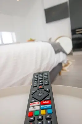 a remote control sitting on top of a table at Smart Appart - City in Brussels