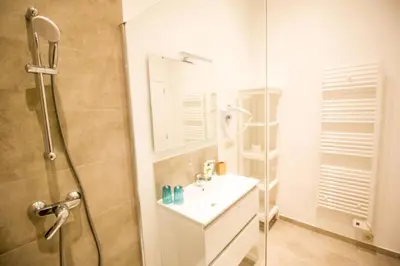 a bathroom with a sink and a glass shower at Smart Appart - City in Brussels