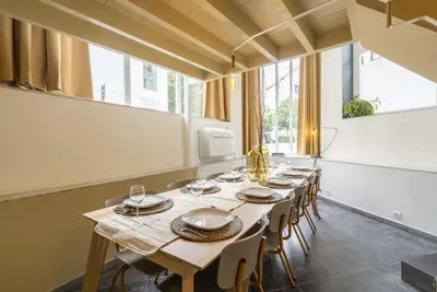 a long dining room with a long table and chairs at SHWAY60 Family House in Antwerp