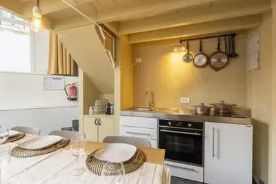 a kitchen with a table with chairs and a sink at SHWAY60 Family House in Antwerp