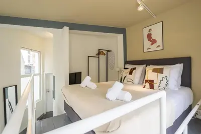 a bedroom with two beds with white towels at SHWAY60 Family House in Antwerp