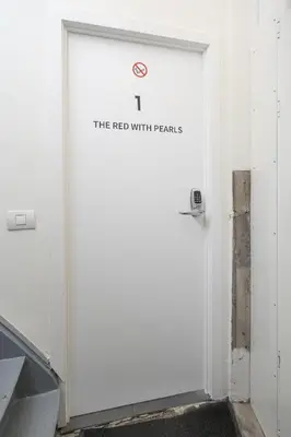 a white door with a sign that reads the red with perpes at SHWAY60 Family House in Antwerp