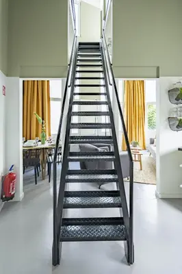 a metal spiral staircase in a living room at SHWAY60 Family House in Antwerp