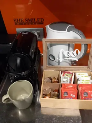 a kitchen counter with a tea pot and a cup at nice and cosy place with jacuzzi and sauna to relax in the centre of antwerp in Antwerp