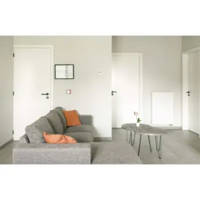 a living room with a couch and a table at Lianko - Vakantiewoning in Bekkevoort