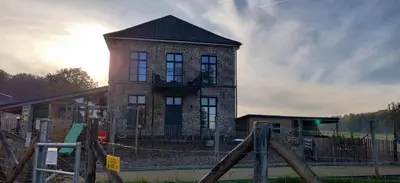 a brick building with a balcony on top of it at Lianko - Vakantiewoning in Bekkevoort