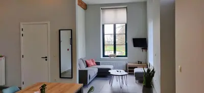 a living room with a couch and a table at Lianko - Vakantiewoning in Bekkevoort