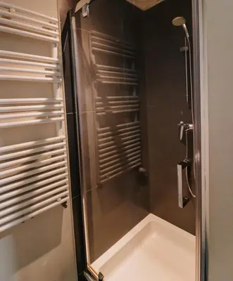 a shower with a glass door in a bathroom at Central and Cozy in Brussels in Brussels