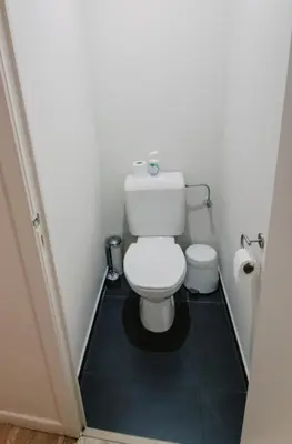 a bathroom with a white toilet in a room at Central and Cozy in Brussels in Brussels