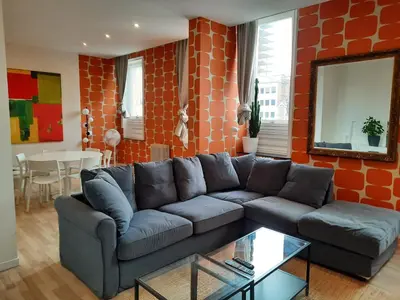 a living room with a couch and a table at Central and Cozy in Brussels in Brussels