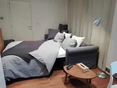 a bedroom with a bed with a chair and a table at Super central in Brussels in Brussels
