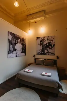 a bedroom with a bed with two pictures on the wall at Super central in Brussels in Brussels