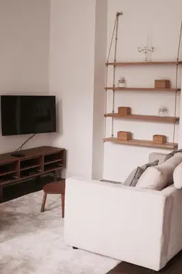 a living room with a white couch and a tv at Super central in Brussels in Brussels