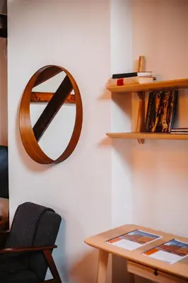 a mirror hanging on a wall next to a table at Super central in Brussels in Brussels