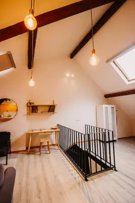 an attic room with a desk and a table at Super central in Brussels in Brussels