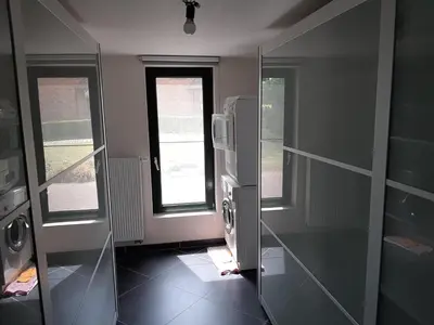 a bathroom with a glass shower stall and a window at Lemen huis Houwaart in Tielt